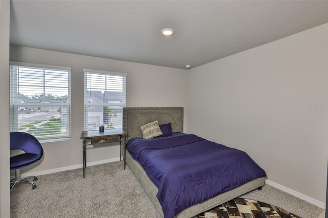 7709 Imagination Pl, Wesley Chapel, FL 33545 - bedroom featuring baseboards, carpet floors, and a textured ceiling
