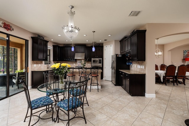 4611 Grand Preserve Pl, Palm Harbor, FL 34684 - kitchen featuring a chandelier, appliances with stainless steel finishes, light tile patterned floors, and recessed lighting