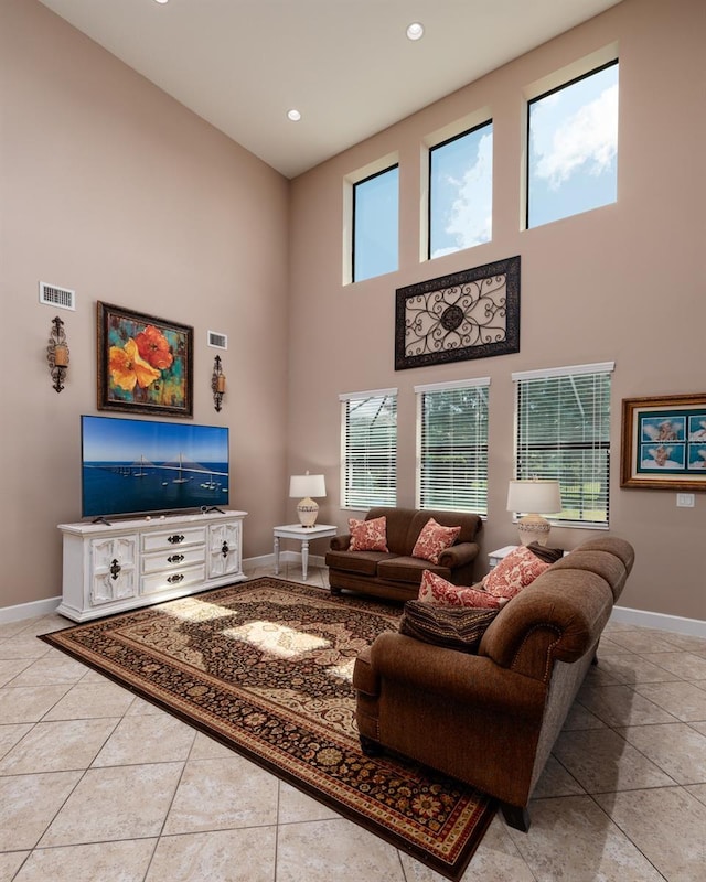 4611 Grand Preserve Pl, Palm Harbor, FL 34684 - living room featuring baseboards, a towering ceiling, recessed lighting, and light tile patterned floors