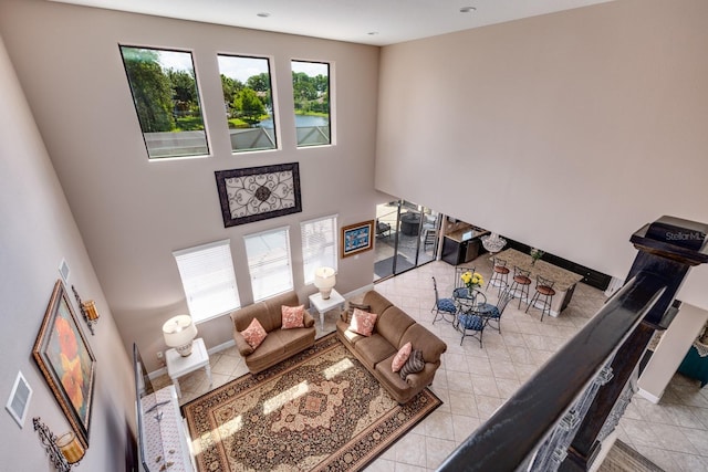 4611 Grand Preserve Pl, Palm Harbor, FL 34684 - tiled living room featuring a towering ceiling and baseboards