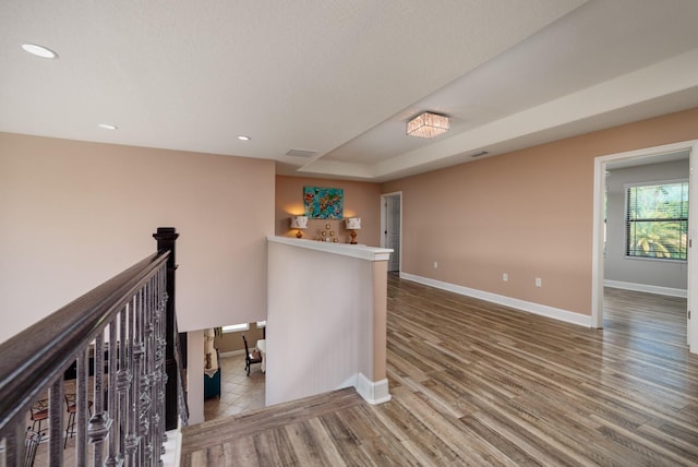 4611 Grand Preserve Pl, Palm Harbor, FL 34684 - hall featuring baseboards, wood finished floors, an upstairs landing, and recessed lighting
