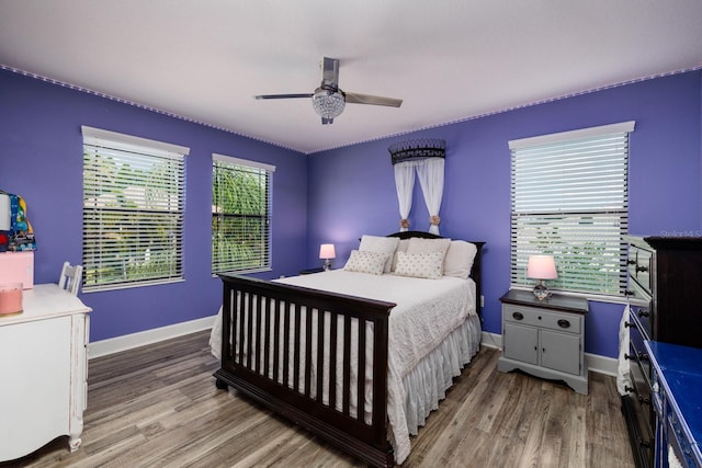 4611 Grand Preserve Pl, Palm Harbor, FL 34684 - bedroom featuring wood finished floors, baseboards, and a ceiling fan