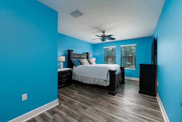 4611 Grand Preserve Pl, Palm Harbor, FL 34684 - bedroom with baseboards, dark wood-style flooring, ceiling fan, and a textured ceiling