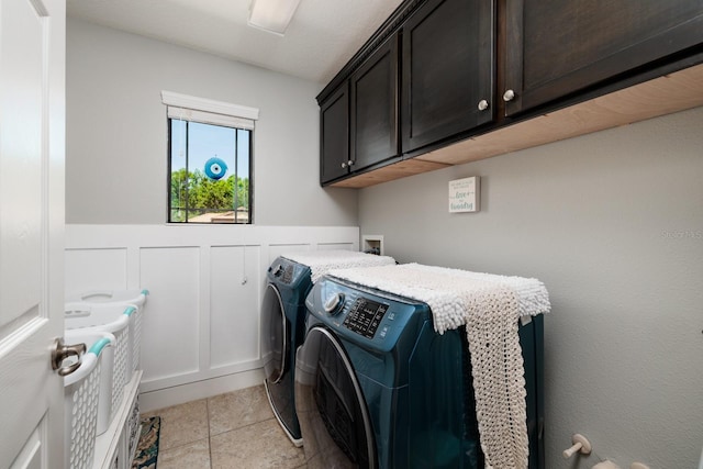 4611 Grand Preserve Pl, Palm Harbor, FL 34684 - laundry area with cabinet space, washer and dryer, light tile patterned floors, and a wainscoted wall