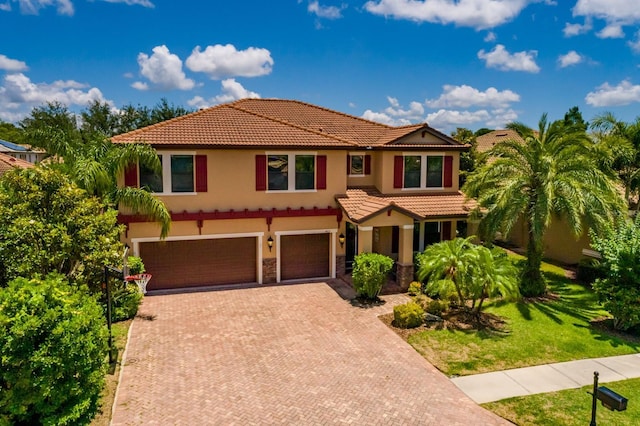 4611 Grand Preserve Pl, Palm Harbor, FL 34684 - mediterranean / spanish home featuring a tile roof, an attached garage, stucco siding, and decorative driveway