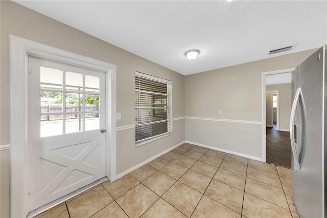 204 Cove Ct, Clearwater, FL 33756 - doorway to outside with light tile patterned floors and baseboards