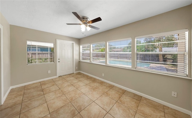 204 Cove Ct, Clearwater, FL 33756 - unfurnished room featuring healthy amount of natural light, light tile patterned floors, ceiling fan, and baseboards