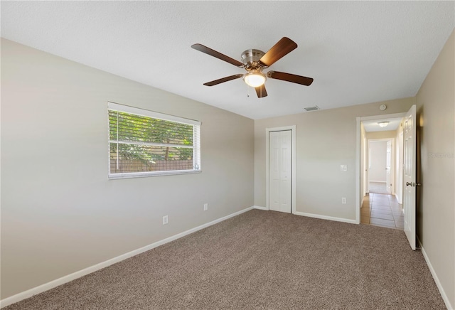 204 Cove Ct, Clearwater, FL 33756 - unfurnished bedroom with carpet floors, a closet, ceiling fan, and baseboards