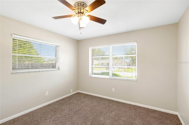 204 Cove Ct, Clearwater, FL 33756 - carpeted empty room with baseboards and ceiling fan
