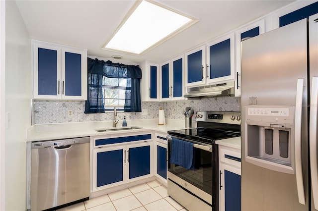 35145 Whispering Oaks Blvd, Dade City, FL 33523 - kitchen featuring appliances with stainless steel finishes, under cabinet range hood, blue cabinetry, a sink, and light tile patterned flooring