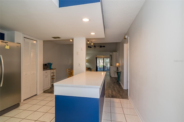 35145 Whispering Oaks Blvd, Dade City, FL 33523 - kitchen featuring freestanding refrigerator, light tile patterned flooring, light countertops, baseboards, and recessed lighting