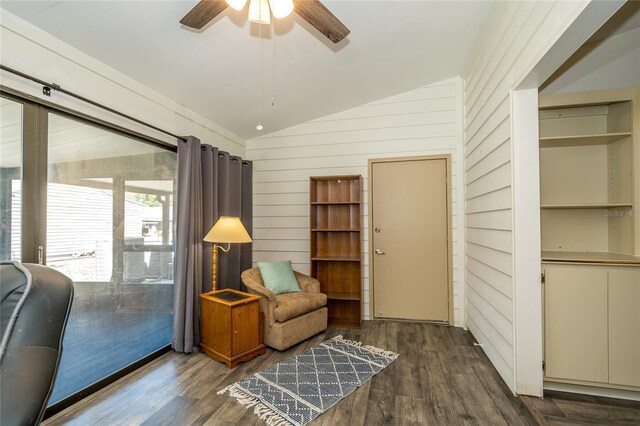 35145 Whispering Oaks Blvd, Dade City, FL 33523 - sitting room with vaulted ceiling, ceiling fan, dark wood-type flooring, and wood walls