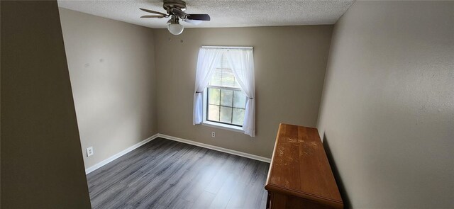 35145 Whispering Oaks Blvd, Dade City, FL 33523 - unfurnished room featuring ceiling fan, a textured ceiling, dark wood-style floors, and baseboards
