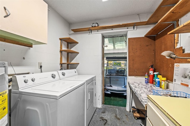 laundry area featuring washing machine and dryer, water heater, and dark colored carpet