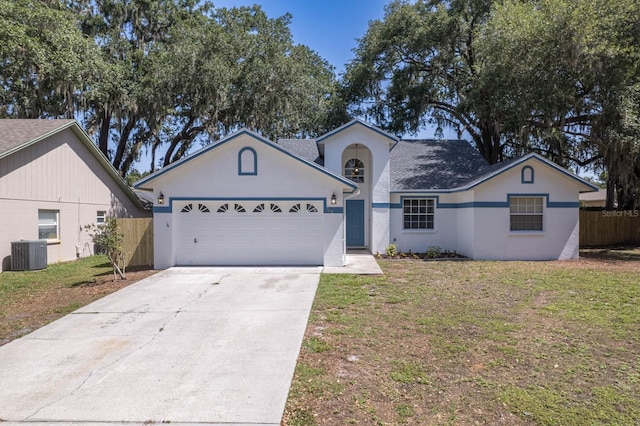 748 Sagewood Dr, Lakeland, FL 33813 - ranch-style house with cooling unit, a garage, driveway, and stucco siding