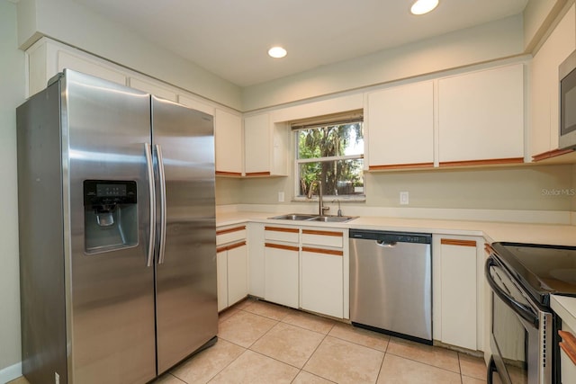 748 Sagewood Dr, Lakeland, FL 33813 - kitchen featuring appliances with stainless steel finishes, a sink, light tile patterned flooring, light countertops, and recessed lighting