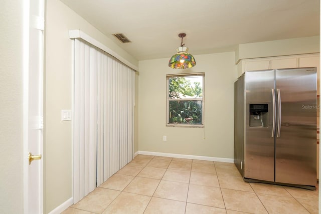 748 Sagewood Dr, Lakeland, FL 33813 - kitchen featuring stainless steel fridge, light tile patterned floors, white cabinetry, baseboards, and decorative light fixtures