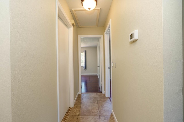 748 Sagewood Dr, Lakeland, FL 33813 - hallway featuring light tile patterned floors, baseboards, and a textured wall