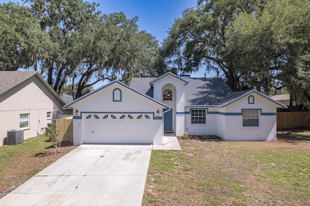 748 Sagewood Dr, Lakeland, FL 33813 - view of front of home featuring a garage, driveway, stucco siding, and a shingled roof