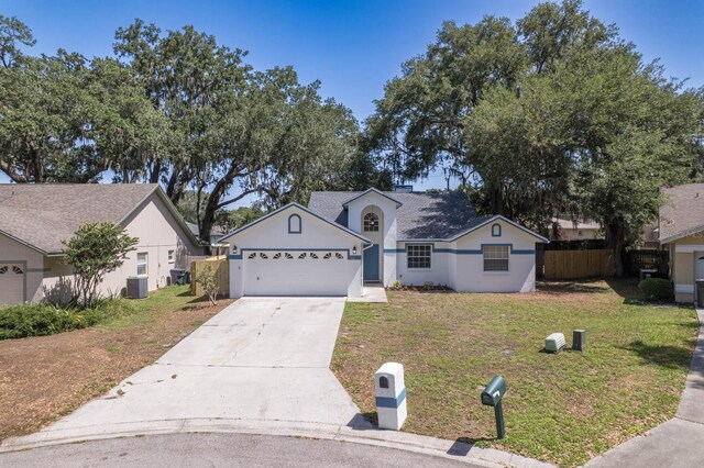 748 Sagewood Dr, Lakeland, FL 33813 - view of front of house featuring driveway, cooling unit, a garage, and stucco siding