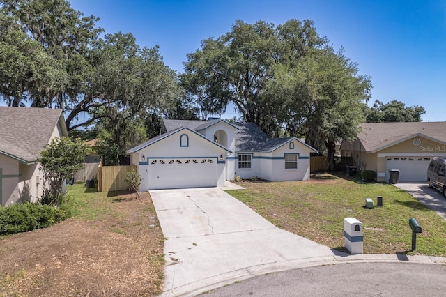 748 Sagewood Dr, Lakeland, FL 33813 - view of front of home with driveway, an attached garage, and stucco siding