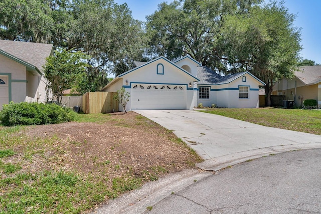 748 Sagewood Dr, Lakeland, FL 33813 - ranch-style home with concrete driveway, stucco siding, and a garage