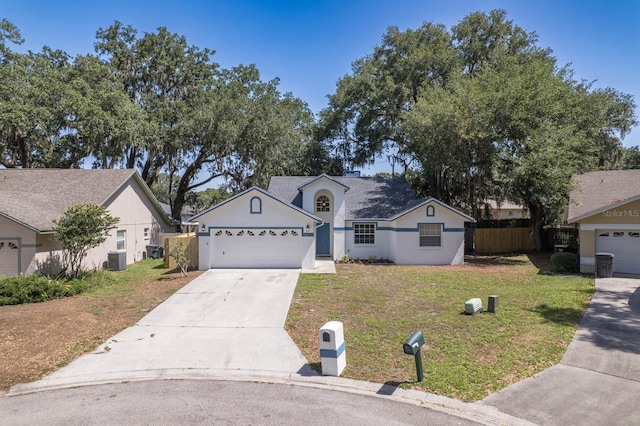 748 Sagewood Dr, Lakeland, FL 33813 - view of front of home with concrete driveway, stucco siding, an attached garage, and central air condition unit