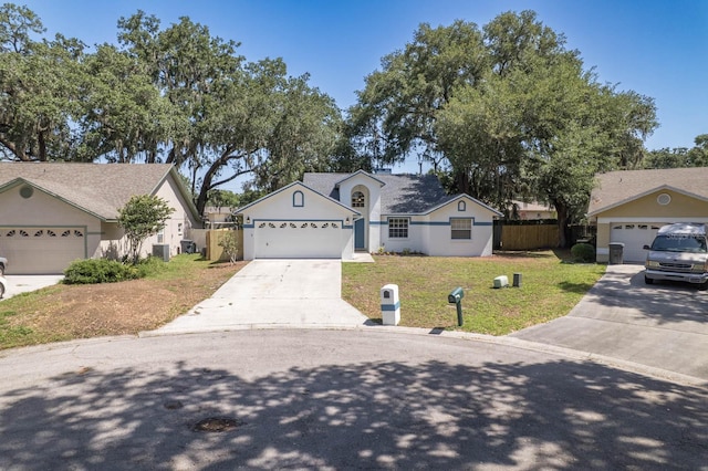 748 Sagewood Dr, Lakeland, FL 33813 - view of front of house with concrete driveway, stucco siding, and an attached garage