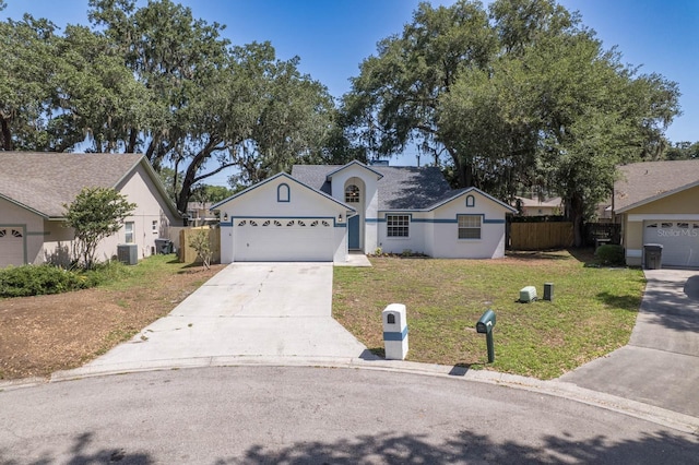 748 Sagewood Dr, Lakeland, FL 33813 - view of front of home featuring driveway, an attached garage, stucco siding, and central air condition unit