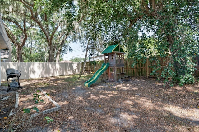 748 Sagewood Dr, Lakeland, FL 33813 - fenced backyard featuring a playground