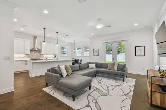 807 W Kentucky Ave, Tampa, FL 33603 - living room with crown molding, recessed lighting, dark wood finished floors, and baseboards