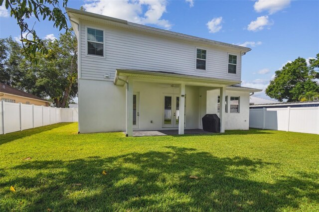 807 W Kentucky Ave, Tampa, FL 33603 - back of property with french doors, stucco siding, and ceiling fan