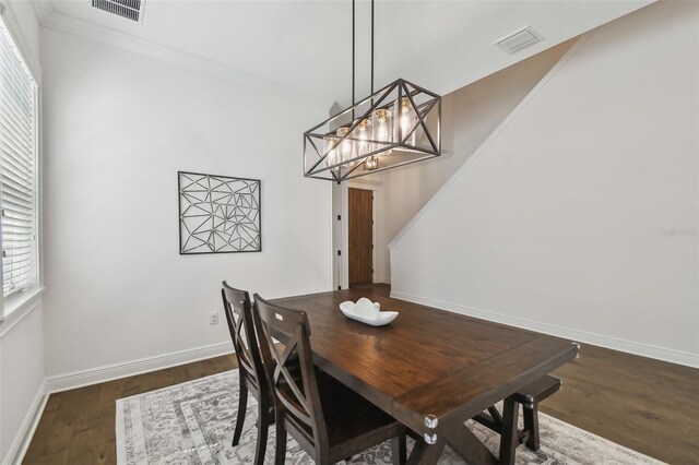 807 W Kentucky Ave, Tampa, FL 33603 - dining room featuring wood finished floors, baseboards, a chandelier, and ornamental molding