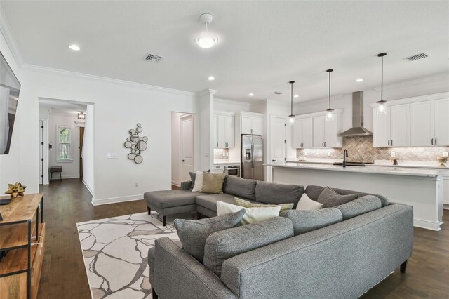 807 W Kentucky Ave, Tampa, FL 33603 - living area featuring ornamental molding, dark wood-style flooring, recessed lighting, and baseboards