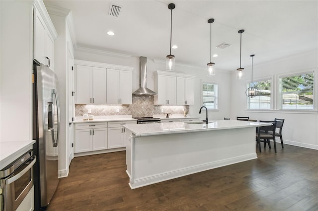 807 W Kentucky Ave, Tampa, FL 33603 - kitchen with wall chimney range hood, appliances with stainless steel finishes, a sink, light countertops, and tasteful backsplash