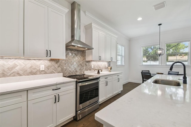 807 W Kentucky Ave, Tampa, FL 33603 - kitchen with electric range, a sink, wall chimney range hood, white cabinets, and ornamental molding