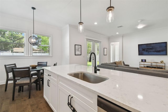 807 W Kentucky Ave, Tampa, FL 33603 - kitchen featuring a sink, crown molding, open floor plan, hanging light fixtures, and white cabinetry
