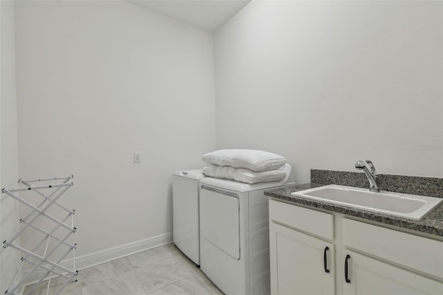 807 W Kentucky Ave, Tampa, FL 33603 - clothes washing area with washing machine and dryer, cabinet space, light marble finish flooring, and baseboards