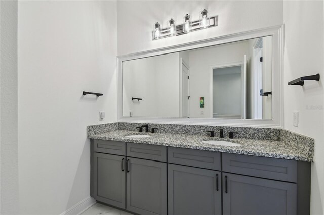 807 W Kentucky Ave, Tampa, FL 33603 - bathroom featuring double vanity and baseboards