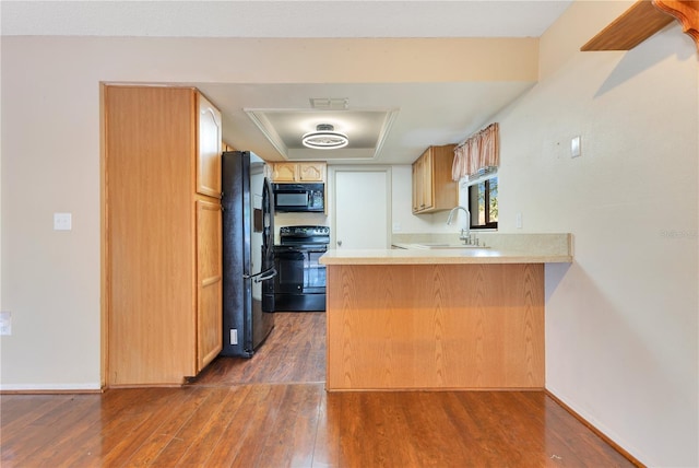 728 Waterbridge Dr, Winter Haven, FL 33880 - kitchen with black appliances, a sink, a peninsula, and dark wood-style floors