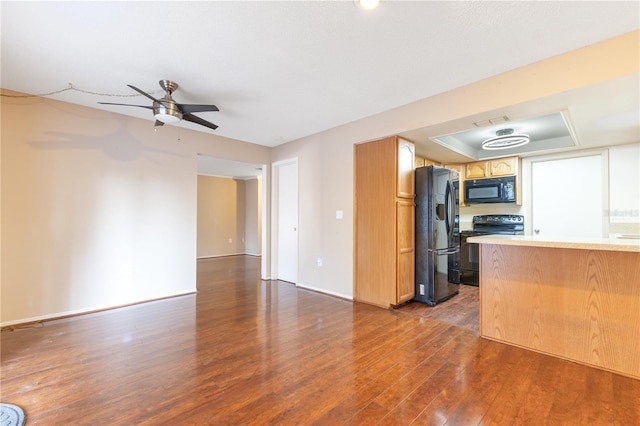 728 Waterbridge Dr, Winter Haven, FL 33880 - unfurnished living room with dark wood-style flooring, a ceiling fan, baseboards, and a raised ceiling