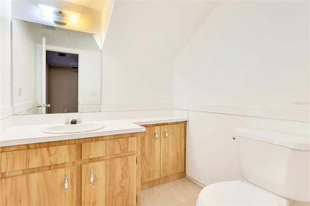 728 Waterbridge Dr, Winter Haven, FL 33880 - half bathroom with toilet, vanity, wainscoting, and tile patterned floors