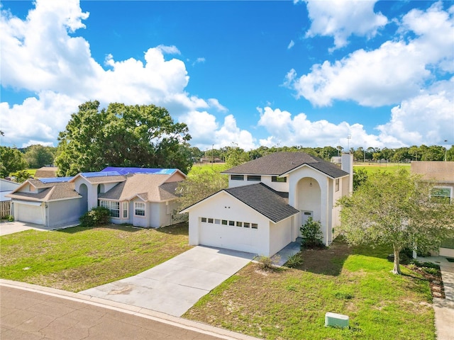 728 Waterbridge Dr, Winter Haven, FL 33880 - view of front of house featuring a front lawn, concrete driveway, a chimney, stucco siding, and a garage