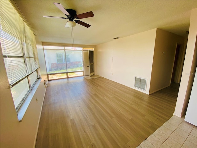 4351 Tahitian Gardens Cir Unit H, Holiday, FL 34691 - unfurnished room with a ceiling fan, wood finished floors, and a textured ceiling