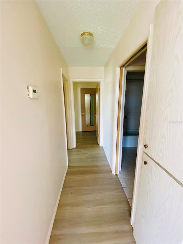 4351 Tahitian Gardens Cir Unit H, Holiday, FL 34691 - hall with baseboards and light wood-type flooring