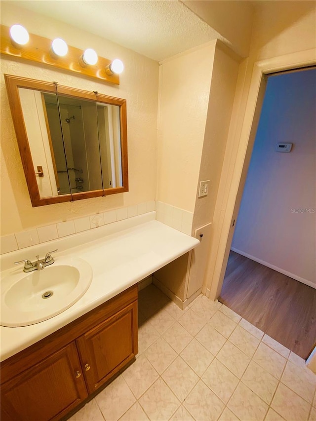 4351 Tahitian Gardens Cir Unit H, Holiday, FL 34691 - bathroom with vanity, a shower with shower door, tile patterned floors, and a textured ceiling