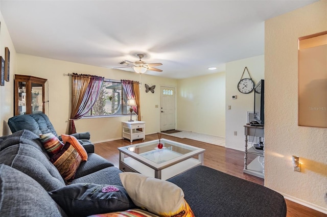 2308 Rio Cir, Spring Hill, FL 34608 - living area featuring wood finished floors, a ceiling fan, and baseboards