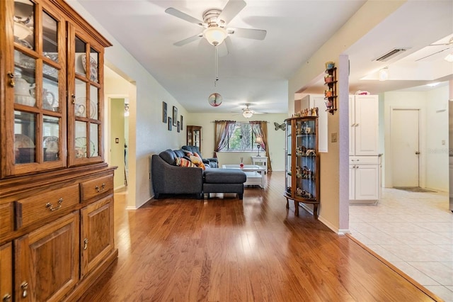2308 Rio Cir, Spring Hill, FL 34608 - living area with a ceiling fan, light wood-type flooring, and baseboards