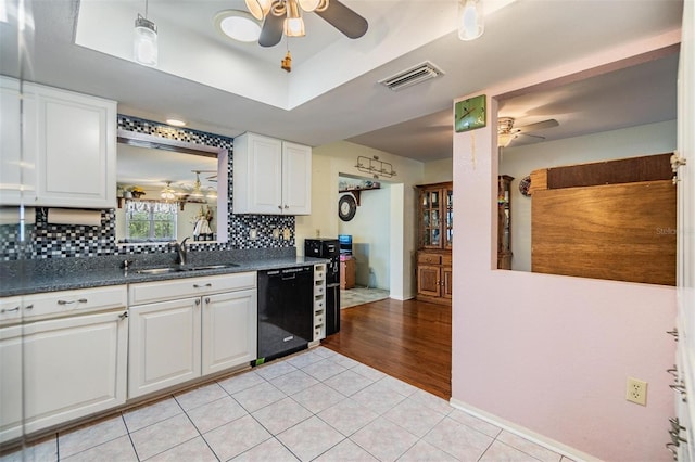 2308 Rio Cir, Spring Hill, FL 34608 - kitchen featuring a ceiling fan, dishwasher, a sink, white cabinetry, and tasteful backsplash