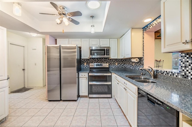 2308 Rio Cir, Spring Hill, FL 34608 - kitchen featuring appliances with stainless steel finishes, a raised ceiling, a sink, ceiling fan, and decorative backsplash